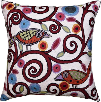 White embroidered decorative pillow cover with colorful birds and swirling motifs
