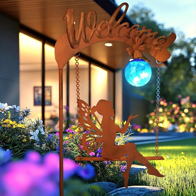 Solar fairy garden light with rust stake, fairy cutout, and glowing blue sphere in yard