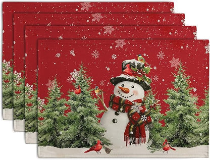 Set of 4 red Christmas linen placemats with snowman, pine trees, and red cardinals