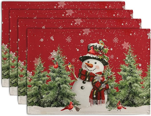 Set of 4 red Christmas linen placemats with snowman, pine trees, and red cardinals