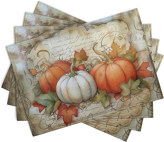 Rectangular set of fall placemats with orange pumpkins, white pumpkin, and red leaf print