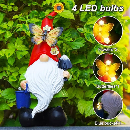 Solar LED garden gnome statue with glowing butterfly lights, red cap, white beard, blue bucket