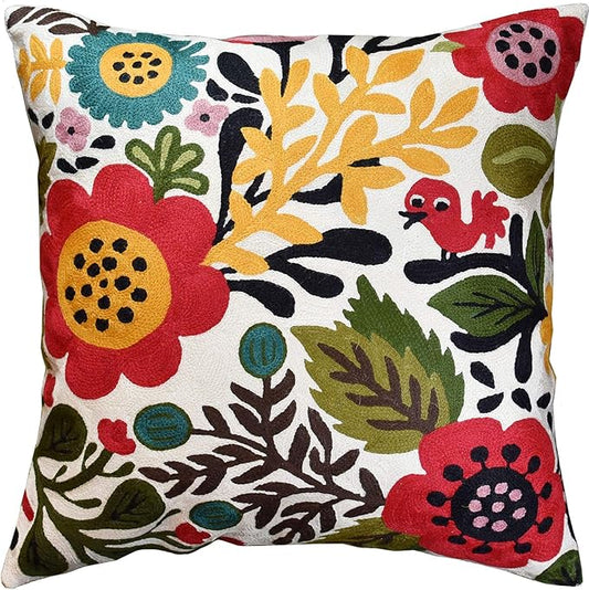 Floral bird pillow cover in red, yellow, teal, and green on white fabric.