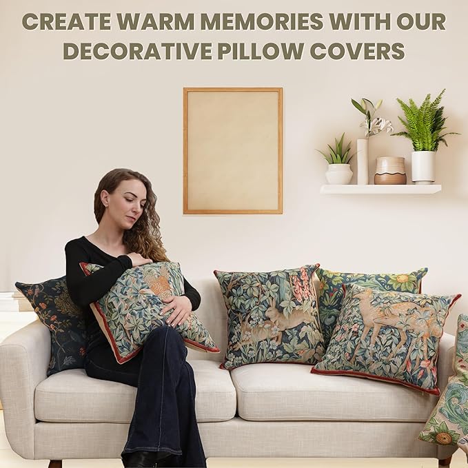 Square pillow cover on couch, dark blue with green leaves and orange flower design