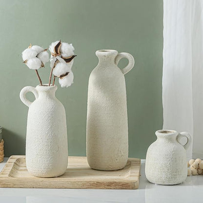 Set of 3 white ceramic vases with loop handles, tall central vase with two shorter matching vases