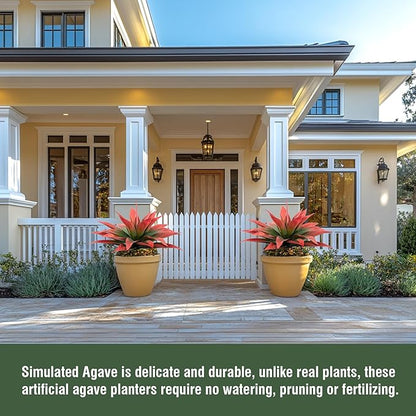 Two red and green faux agave plants in yellow pots on a porch walkway