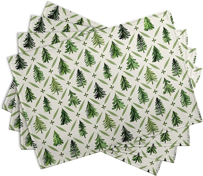 Set of 4 pine tree Christmas placemats with sage green trees and star motifs on light base.