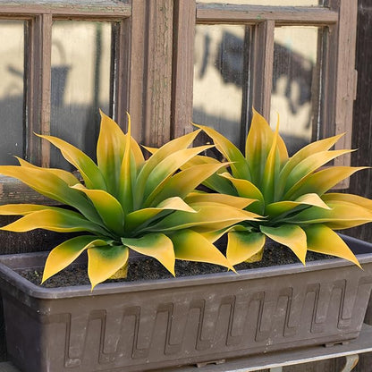 Yellow-green faux agave plants in rectangular planter with faux trunk stems