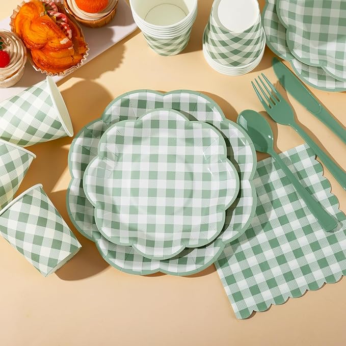 Sage green and white gingham dessert plates, cups, and forks on a tabletop