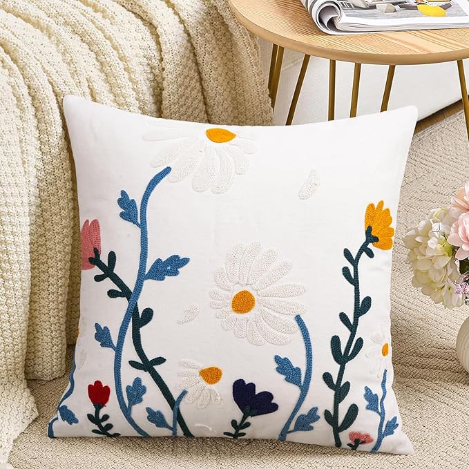 White cotton square pillow cover with embroidered blue floral vine and yellow flowers
