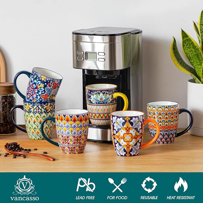 Boho ceramic coffee mug set with handles, multi-color patterned cups arranged near a coffee maker
