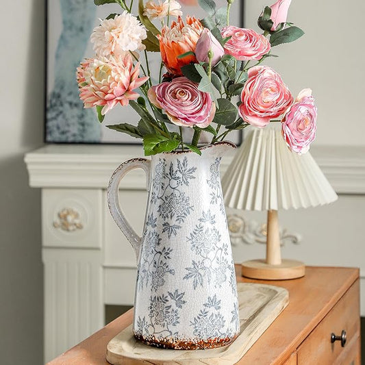 Blue and white ceramic pitcher vase with double handles, floral leaf pattern and speckled base