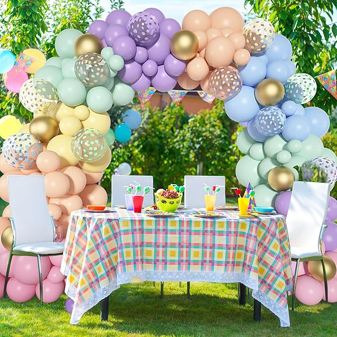Pastel balloon arch garland with gold confetti and patterned balloons forming a full rainbow arch