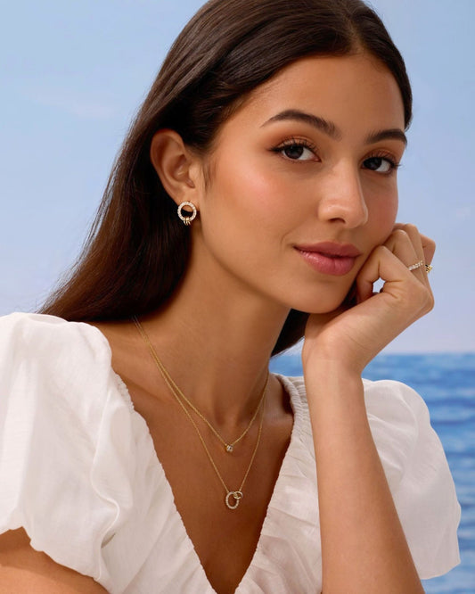 Gold pave circle stud earrings on model
