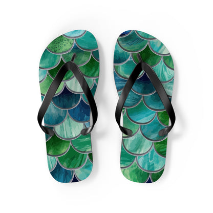 Two mermaid-scale flip flops with black straps and layered sea-scale artwork
