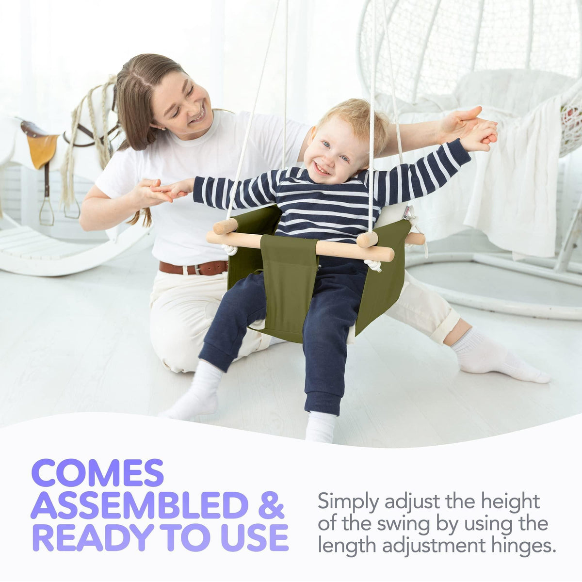 Olive canvas hanging swing with white cushions and wooden arm dowels, secured with belt