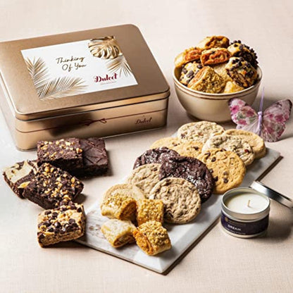Gift basket tin treats: assorted cookies, brownies, and candle on serving tray