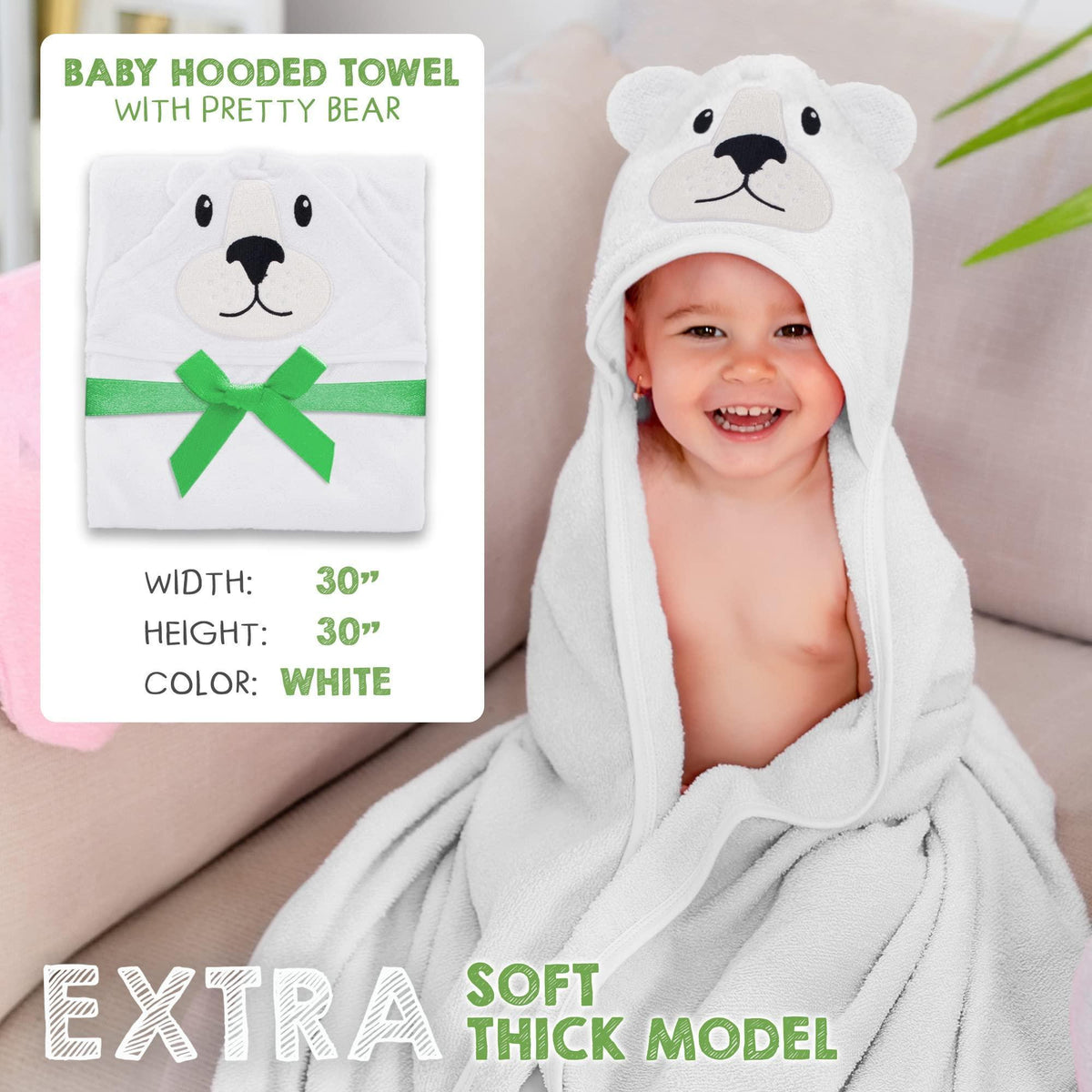 White hooded baby towel with bear face and green bow, folded square
