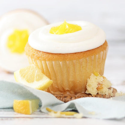 Lemon zest cupcake with white icing and yellow citrus garnish
