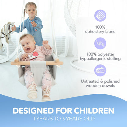 Gray canvas baby hanging swing seat with wooden bars and safety belt, in use