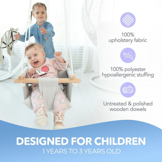 Gray canvas baby hanging swing seat with wooden bars and safety belt, in use