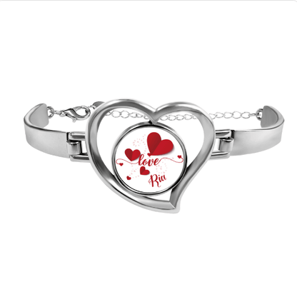 Heart charm bracelet with silver heart locket and red heart design reading "Love Rid"