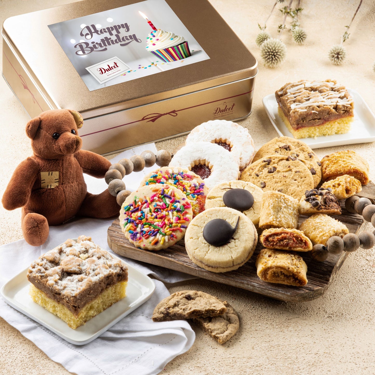Happy Holidays pastry gift tin with assorted cookies, pastries, and teddy bear