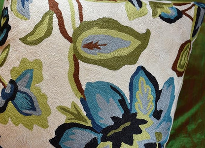 Side view floral pillow cover in cream with blue and green blossoms and brown stems
