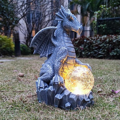 Blue dragon garden statue with glowing orb and jagged stone base, solar light