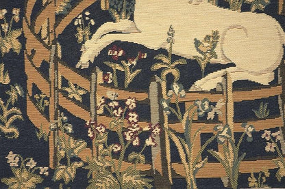 Close-up navy jacquard pillow cover with unicorn resting, plants, and ornate lattice