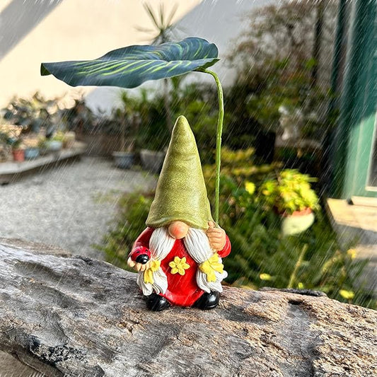 Garden gnome statue with red outfit and green leaf umbrella, holding small flowers