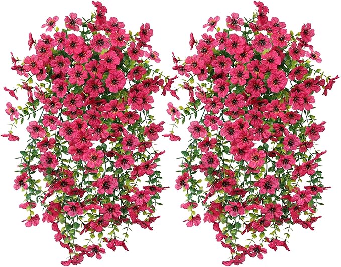 Two hot pink faux daisy hanging flower bundles with trailing green leaves