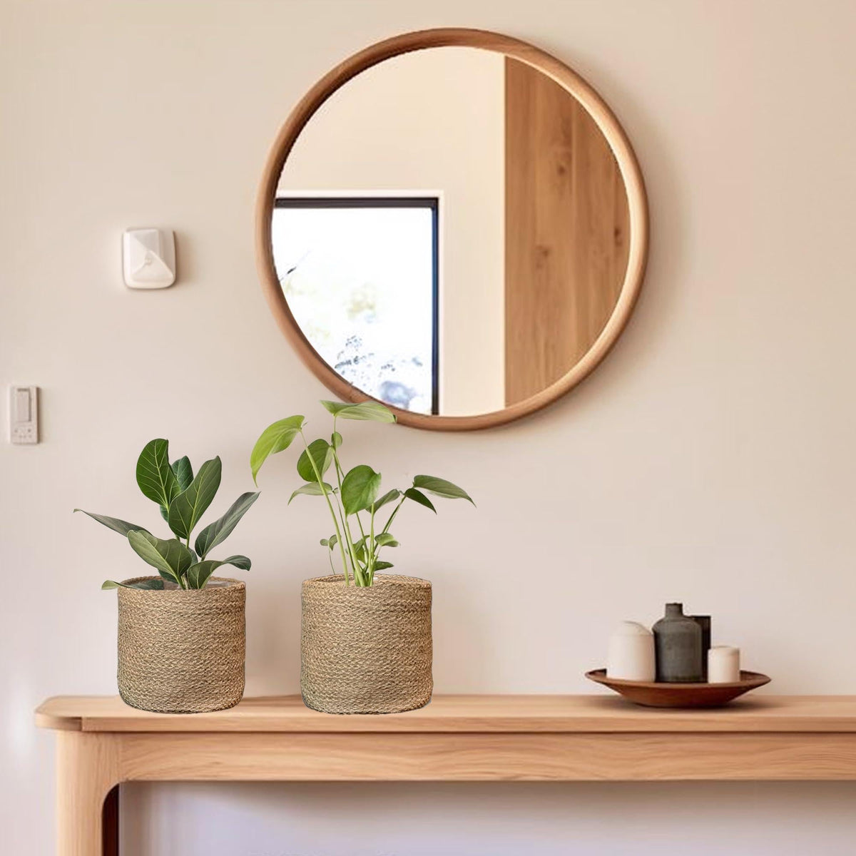 Handwoven jute planter baskets, natural tan, round cylinder with textured weave on a shelf