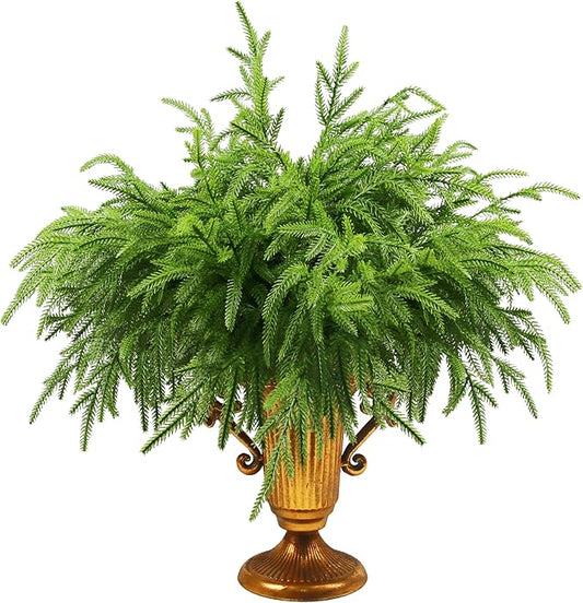 Artificial Norfolk pine branch with dense green needles in gold vase