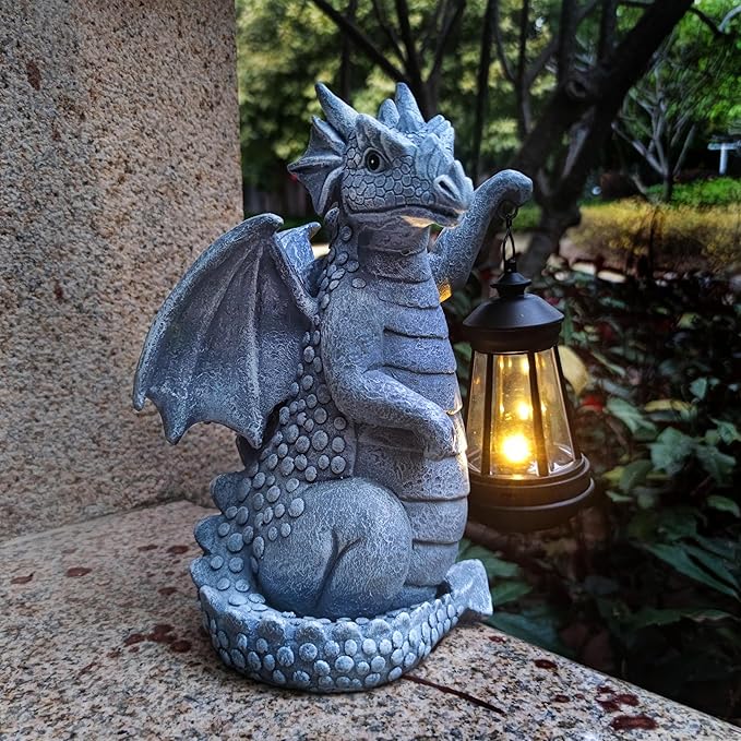 Blue dragon garden statue with open wings and glowing lantern nearby