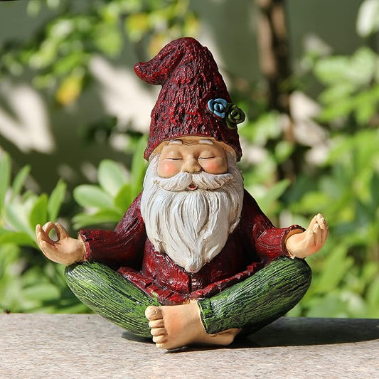 Yoga gnome garden statue in red hat and white beard, cross-legged with hands up