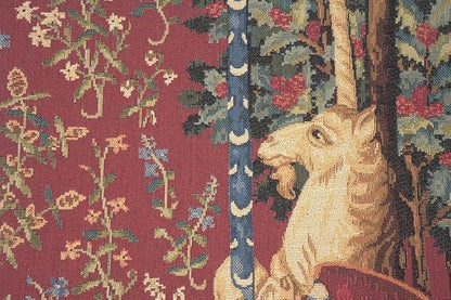 Unicorn tapestry pillow cover corner detail with burgundy floral vines and part of unicorn