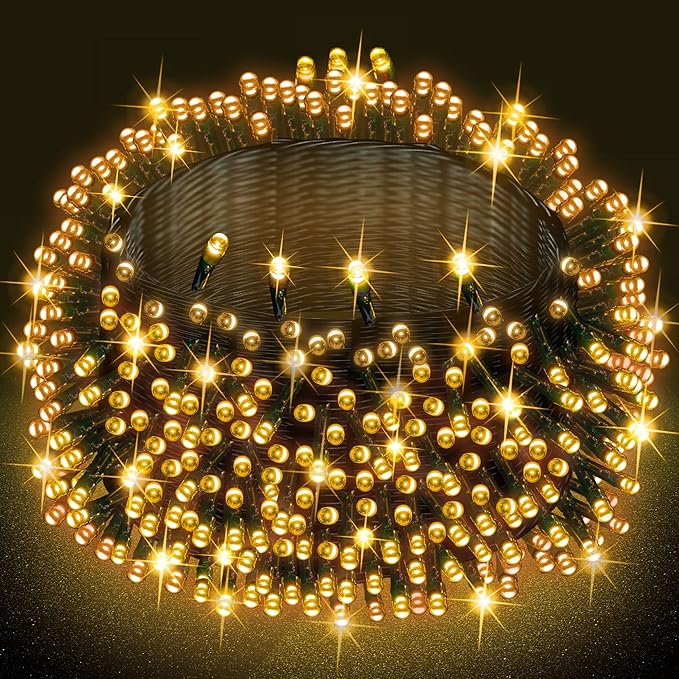 Warm white LED Christmas string lights with small bulbs on green wire, glowing