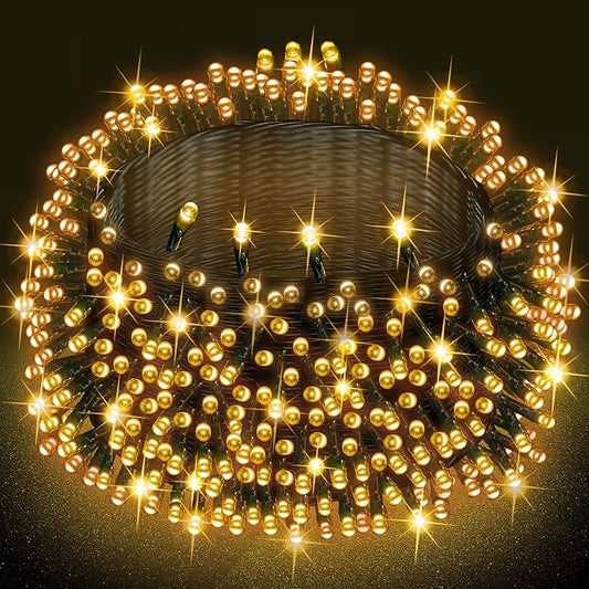 Warm white LED fairy string lights on a bundle, green wire, glowing bulbs