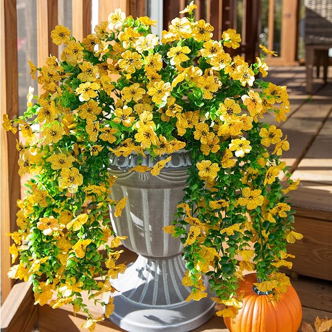 Yellow faux daisy hanging flower bundle with trailing green eucalyptus-style leaves