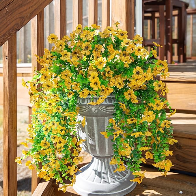 Yellow faux daisy hanging flower bundle with dense trailing green eucalyptus-style leaves
