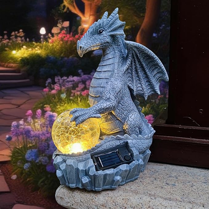Blue dragon garden statue sitting with glowing orb and solar panel in stone base