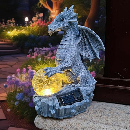 Blue dragon garden statue sitting with glowing orb and solar panel in stone base