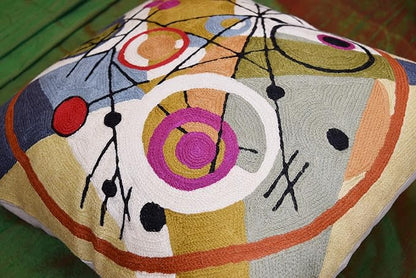 Wool pillow cover close-up with large circular motifs, dots, and black intersecting lines.