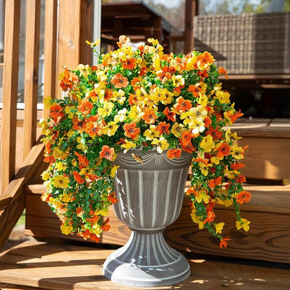 Artificial hanging flower bundle with cascading orange and yellow blooms and green trailing leaves
