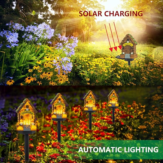 Set of glowing miniature fairy cottage garden lights on black stakes in a flower bed.