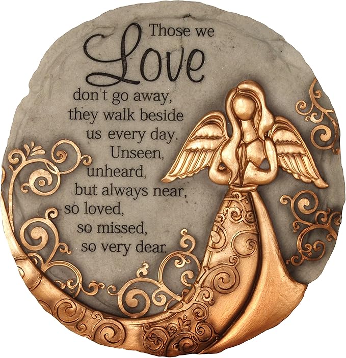 Round garden stone with a bronze angel, decorative scrollwork, and a memorial message