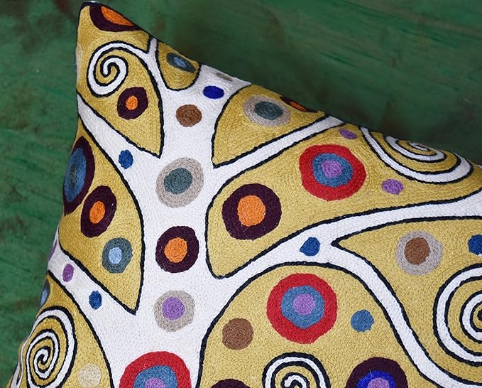 Decorative embroidered pillow cover, yellow and white with multicolor swirl motifs