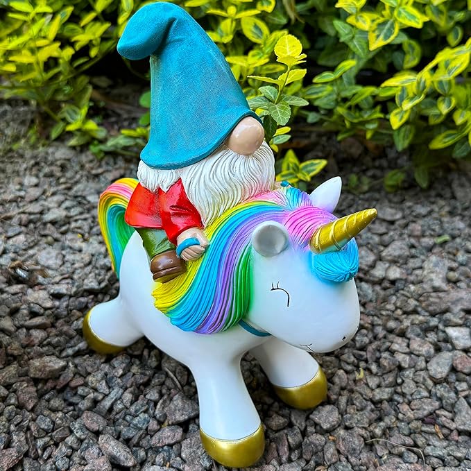 Close side view of unicorn figurine with rainbow mane, horn, and gnome in blue hat