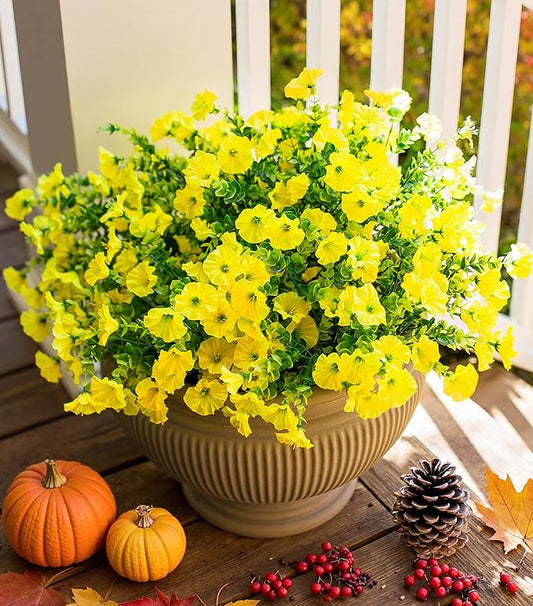 Yellow faux morning glory bundles with eucalyptus-style leaves in a cream planter bowl